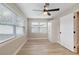 Spacious bedroom with ceiling fan, light flooring, and window blinds at 9240 Whitman Ln, Port Richey, FL 34668