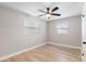 Spacious bedroom with ceiling fan and neutral gray walls at 9240 Whitman Ln, Port Richey, FL 34668