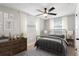 Cozy bedroom with ceiling fan, wood-look floors, and window at 9240 Whitman Ln, Port Richey, FL 34668