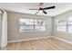Bright bedroom with ceiling fan, light flooring, and window blinds at 9240 Whitman Ln, Port Richey, FL 34668