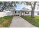 Updated home exterior with a well maintained lawn at 9240 Whitman Ln, Port Richey, FL 34668