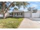 Newly renovated home with a landscaped yard and driveway at 9240 Whitman Ln, Port Richey, FL 34668