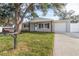 Front view of renovated home with landscaped yard at 9240 Whitman Ln, Port Richey, FL 34668