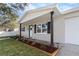 Updated home exterior with attractive landscaping at 9240 Whitman Ln, Port Richey, FL 34668