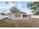 Newly renovated house exterior featuring a screened patio and a spacious backyard at 9240 Whitman Ln, Port Richey, FL 34668