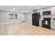 Modern kitchen with gray cabinets, black appliances, and wood-look floors at 9240 Whitman Ln, Port Richey, FL 34668