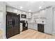 Updated kitchen with gray shaker cabinets and stainless steel appliances at 9240 Whitman Ln, Port Richey, FL 34668