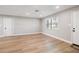 Bright living room with light gray walls and wood-look flooring at 9240 Whitman Ln, Port Richey, FL 34668