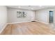 Open living area with light flooring and neutral walls at 9240 Whitman Ln, Port Richey, FL 34668