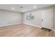 Living room featuring light gray walls, wood-look floors, and a window at 9240 Whitman Ln, Port Richey, FL 34668