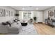 Bright and airy living room with wood-look floors at 9240 Whitman Ln, Port Richey, FL 34668