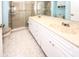 Bathroom boasts dual sinks, ample storage, and a walk-in shower at 9327 Whitstone Ct, New Port Richey, FL 34655