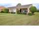 Front view of a single-story house with a covered porch and well-manicured lawn at 9327 Whitstone Ct, New Port Richey, FL 34655