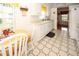 Bright kitchen features white cabinets, tile floor, and a breakfast nook at 9327 Whitstone Ct, New Port Richey, FL 34655