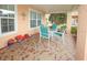 Covered porch with a table and chairs, decorated for the season at 9327 Whitstone Ct, New Port Richey, FL 34655