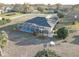 Aerial view of the screened pool and patio on a large lot with established landscaping at 9376 Bearwalk Path, Weeki Wachee, FL 34613
