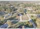 Expansive aerial view of suburban homes with lush green lawns and tree-lined streets, showcasing community living at 9376 Bearwalk Path, Weeki Wachee, FL 34613
