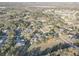 Aerial view of the neighborhood, highlighting the homes among the trees in a wooded landscape at 9376 Bearwalk Path, Weeki Wachee, FL 34613