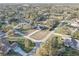 Aerial view of the home and neighborhood, showcasing the mature trees and community layout at 9376 Bearwalk Path, Weeki Wachee, FL 34613