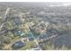 An aerial perspective of homes in a leafy neighborhood offering a blend of nature and community at 9376 Bearwalk Path, Weeki Wachee, FL 34613