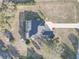 A beautiful aerial view of home featuring a screened-in pool and long driveway at 9376 Bearwalk Path, Weeki Wachee, FL 34613
