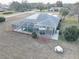 Aerial view of a screened-in pool and patio area in the backyard at 9376 Bearwalk Path, Weeki Wachee, FL 34613
