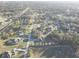 An aerial view of homes nestled within a community among lots of mature trees at 9376 Bearwalk Path, Weeki Wachee, FL 34613