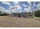 Large backyard showcasing home with pool and screened patio at 9376 Bearwalk Path, Weeki Wachee, FL 34613