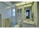 Clean bathroom featuring a tiled shower, vanity, mirror, and storage cabinet at 9376 Bearwalk Path, Weeki Wachee, FL 34613