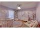 Adorable Bedroom features a crib, dresser, and charming decor at 9376 Bearwalk Path, Weeki Wachee, FL 34613
