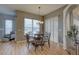 Cozy dining room with hardwood floors, round table, and natural light from the window at 9376 Bearwalk Path, Weeki Wachee, FL 34613