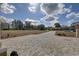 Wide brick driveway leads to a lovely home with expansive front yard and mature landscaping under sunny skies at 9376 Bearwalk Path, Weeki Wachee, FL 34613