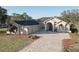 Beautiful home with attached garage, long driveway, and manicured landscaping at 9376 Bearwalk Path, Weeki Wachee, FL 34613