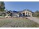 A beautiful home with a long paved driveway and a well-maintained lawn at 9376 Bearwalk Path, Weeki Wachee, FL 34613