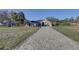 Charming one-story home with a long, patterned brick driveway and meticulously landscaped front yard at 9376 Bearwalk Path, Weeki Wachee, FL 34613