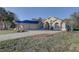 A charming home with a large, paved driveway and an attached 2-car garage at 9376 Bearwalk Path, Weeki Wachee, FL 34613