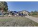 Single Gathering home featuring mature landscaping, a long driveway, and a beautiful exterior at 9376 Bearwalk Path, Weeki Wachee, FL 34613