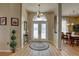 Inviting foyer with decorative glass doors, complemented by elegant lighting and flooring at 9376 Bearwalk Path, Weeki Wachee, FL 34613