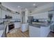 Bright kitchen with white cabinetry, stainless steel appliances, and a functional island at 9376 Bearwalk Path, Weeki Wachee, FL 34613