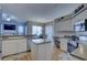 The open kitchen features modern appliances and ample counter space for cooking at 9376 Bearwalk Path, Weeki Wachee, FL 34613