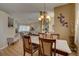Open concept living and dining areas with neutral tones, natural light, and wood flooring at 9376 Bearwalk Path, Weeki Wachee, FL 34613