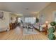 Inviting living room boasts hardwood floors, neutral walls, and plenty of natural light at 9376 Bearwalk Path, Weeki Wachee, FL 34613