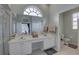 Bright main bathroom featuring double sinks, a large mirror, and a separate toilet room at 9376 Bearwalk Path, Weeki Wachee, FL 34613