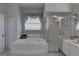 Bright main bathroom with a soaking tub, glass-enclosed shower, and modern finishes at 9376 Bearwalk Path, Weeki Wachee, FL 34613
