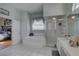 Bright main bathroom with a soaking tub, glass-enclosed shower, and vanity sink at 9376 Bearwalk Path, Weeki Wachee, FL 34613