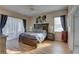 Main bedroom features a ceiling fan, hardwood floors, and natural light from windows at 9376 Bearwalk Path, Weeki Wachee, FL 34613
