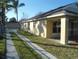 Tan house exterior with driveway and landscaping at 9520 Highland Ridge Dr, Hudson, FL 34667