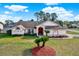 Single-story house with landscaped yard, driveway, and two palm trees at 10244 Gifford Dr, Spring Hill, FL 34608