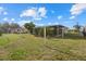 Large backyard featuring an screened in patio and mature landscaping at 106 Aurora E St, Venice, FL 34285
