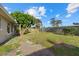 Spacious backyard with a mature tree, a wood fence, and plenty of room for outdoor activities at 106 Aurora E St, Venice, FL 34285